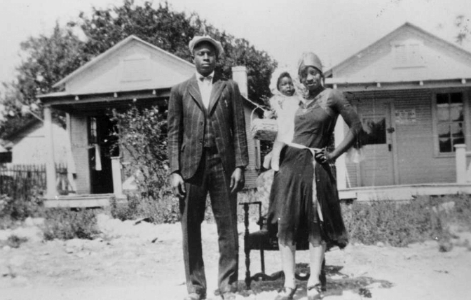 Loil Ellison and Estella Ellison, and daughter Estella Mae Ellison stand in front of their house in East San Antonio in the 1930's